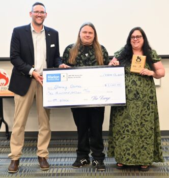 A man and a woman receive a check for $1,000.