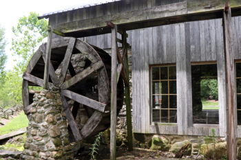A large wooden structure with a water wheel.