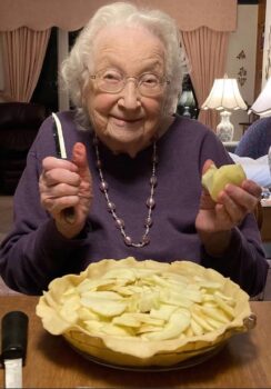 Dorothy holds a paring knife as she makes an apple pie.