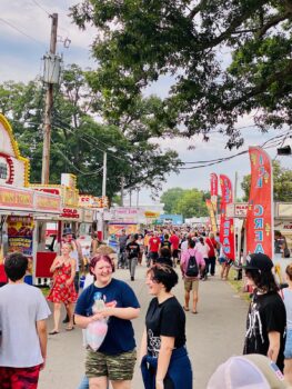 Crowd shot of dozens of people in front of various food stations at the Marion County Fair in 2023.