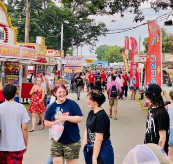 Crowd shot of dozens of people in front of various food stations at the Marion County Fair in 2023.