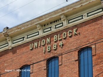 A tall brick building displays: Union Block 1884. 