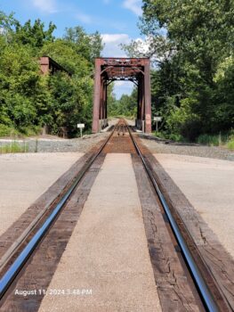 A railroad track leads to a bridge in Caledonia