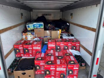 A small U-haul is filled with boxes including a dozen propane heaters.