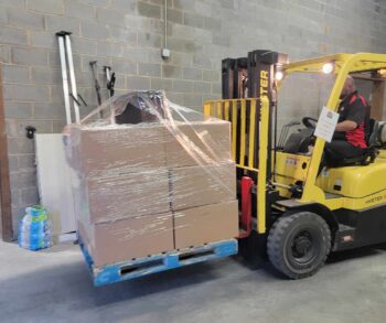 A forklift operater unloads boxes of wrapped goods in North Carolina.