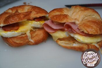 A croissant with eggs, ham, and more. 