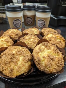 A selection of coffee cups and muffins.