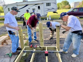 A group of men work around a ramp.