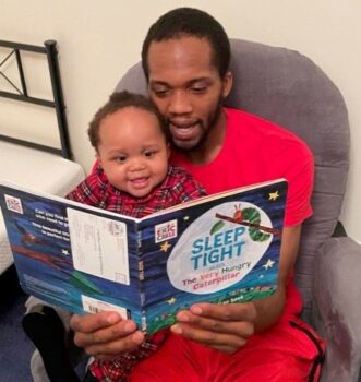 A man reads to a toddler. 