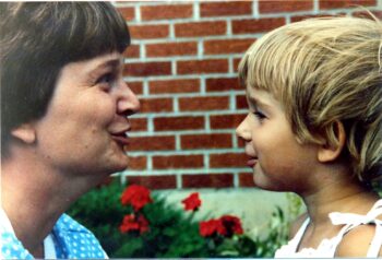 A mom smiles at a preschooler.